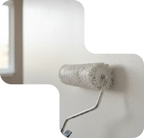 Exterior paint roller leaving a fresh coat of white