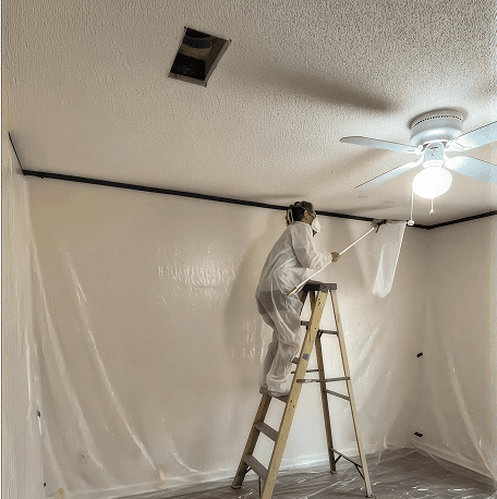 Textured ceiling being smoothed and refinished